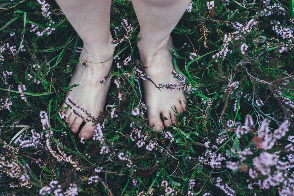 feet on ground with flowers
