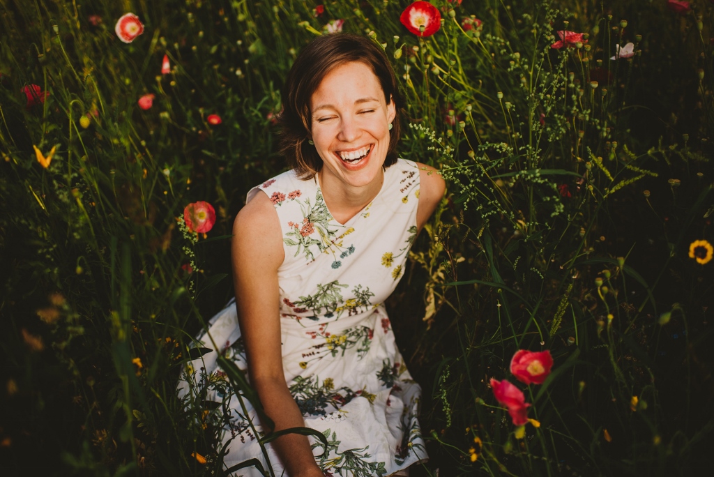 Lisa laughing in a field of flowers