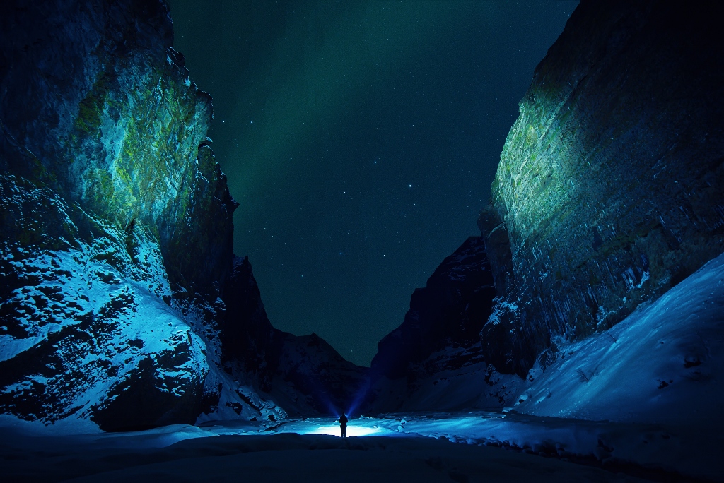 person walking at night in beautiful canyon
